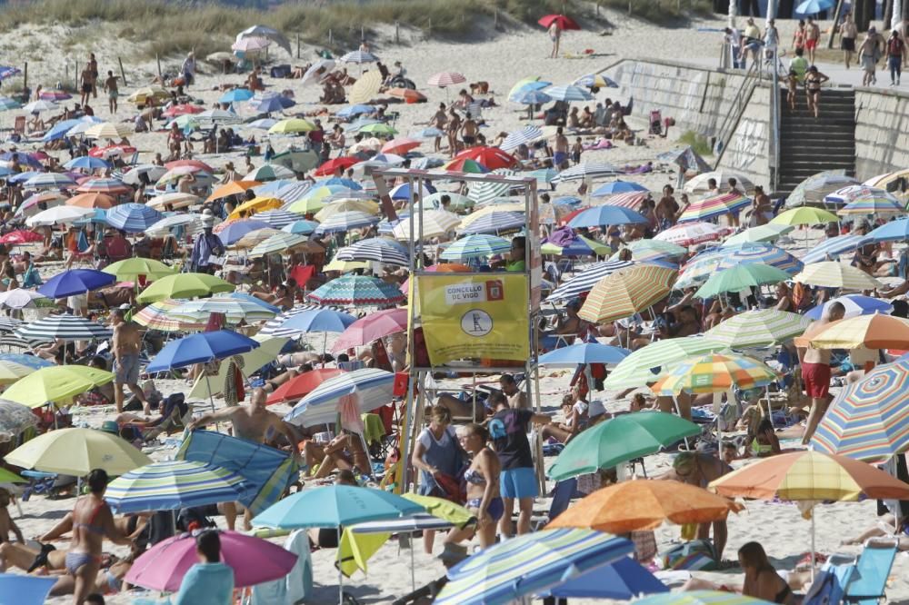 Una plaga de sombrillas irrumpe en Samil durante una jornada muy calurosa en el primer fin de semana de agosto