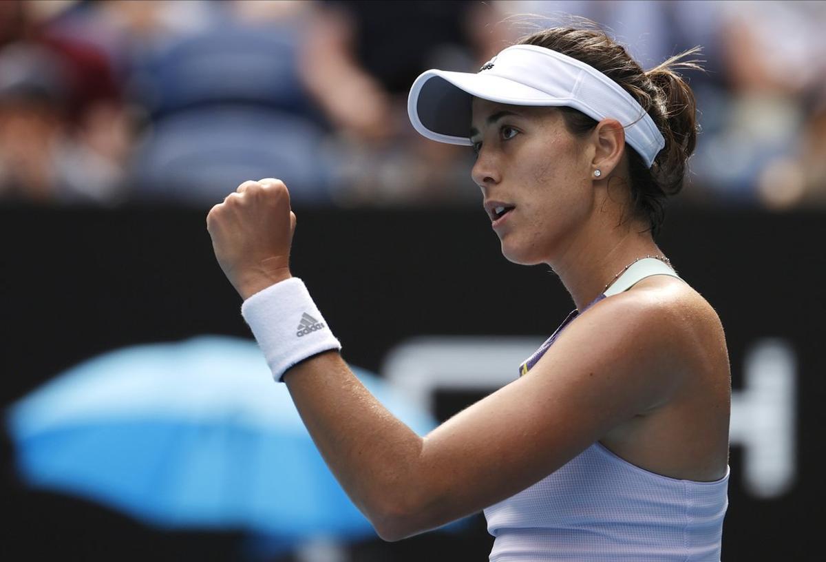 Spain’s Garbine Muguruza reacts after defeating Kiki Bertens of the Netherlands in their fourth round singles match at the Australian Open tennis championship in Melbourne, Australia, Monday, Jan. 27, 2020. (AP Photo/Andy Wong)