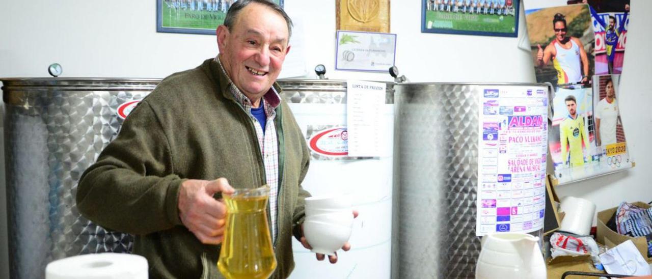 Ángel Nogueira, ayer, con una jarra y tazas de vino en el furancho.