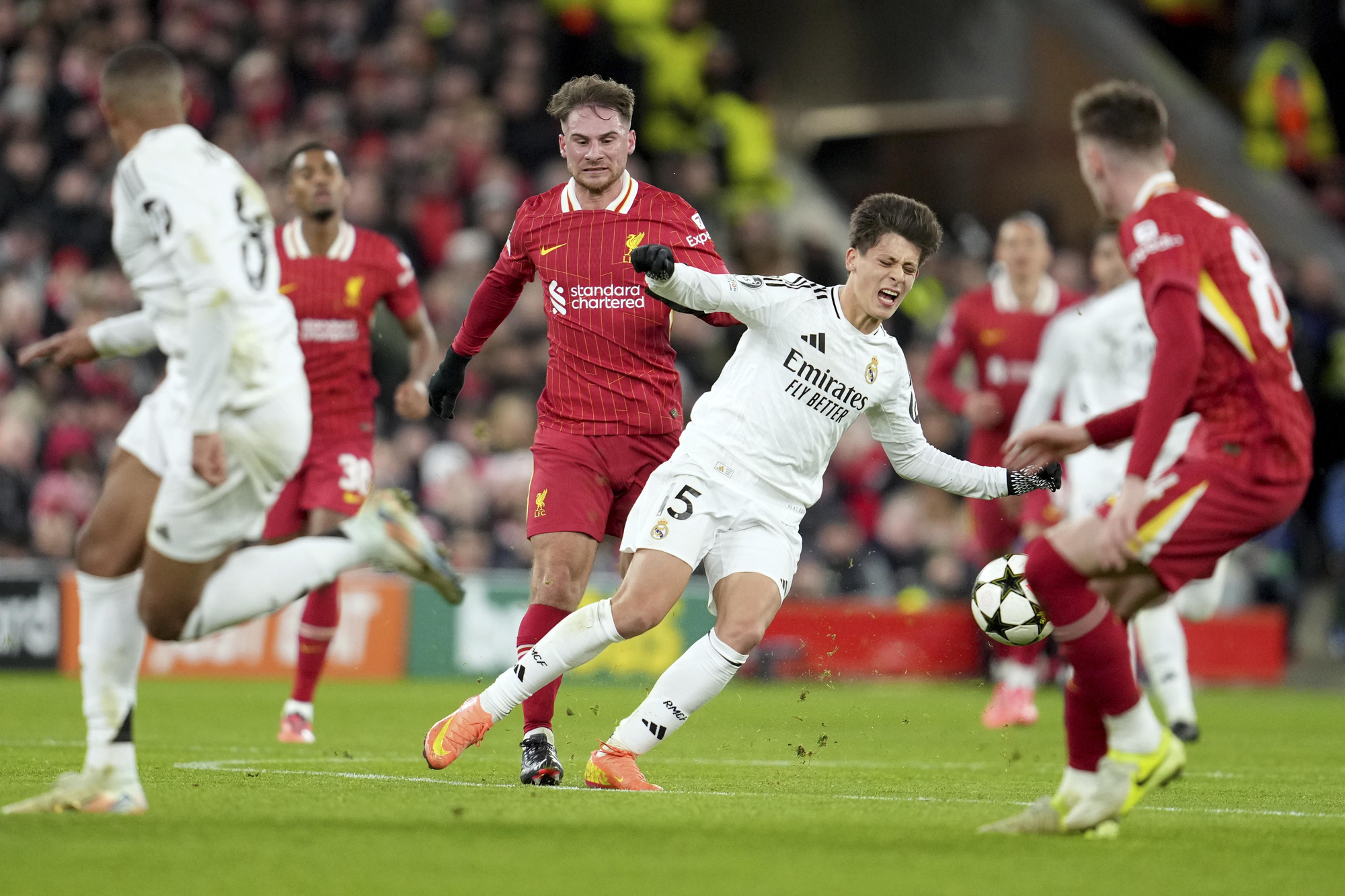 Liverpool's Alexis Mac Allister four Real Madrid's Arda Guler, center right, to see a yellow card during the Champions League opening phase soccer match between Liverpool and Real Madrid at Anfield Stadium, Liverpool, England, Wednesday, Nov. 27, 2024. (AP Photo/Jon Super)