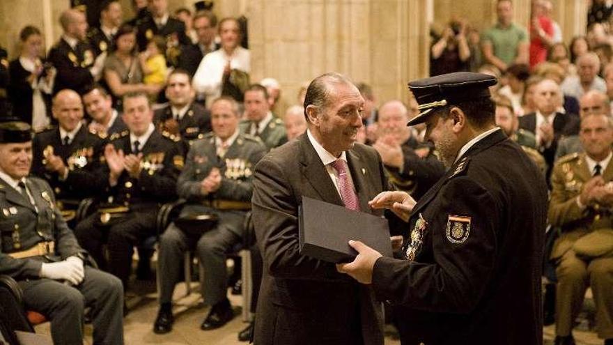 Quini recoge de manos del comisario Dámaso Colunga una placa que le regaló la Policía Nacional en 2016.