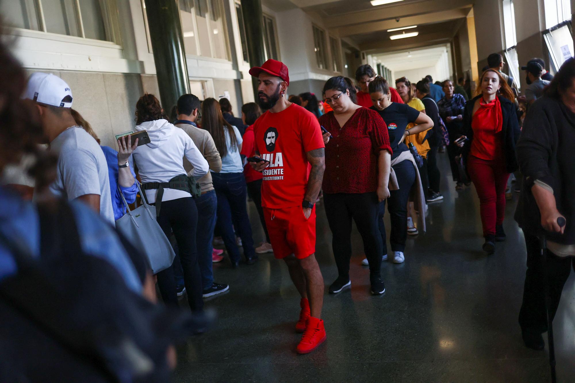 Citizens of Brazil wait in line to cast their vote for their country's election, in Lisbon