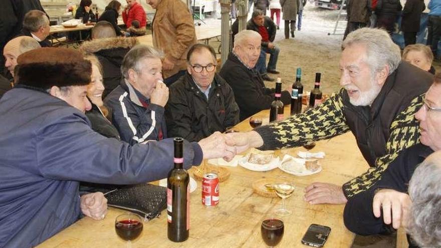 Vecinos disfrutando de un vino en la carpa de la romería. // S.Álvarez