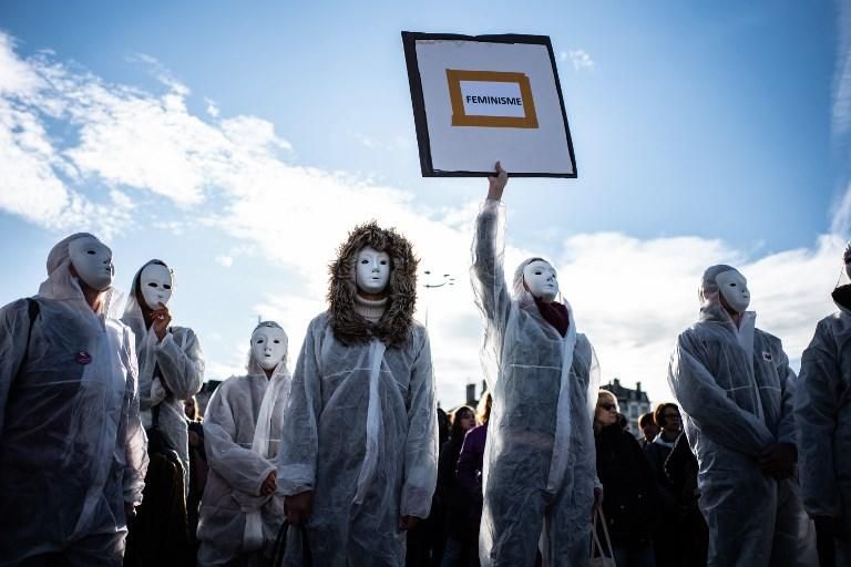 Manifestantes vestidos de blanco llevan pancartas durant una manifestación en Lyon con motivo del Día Internacional de la Eliminación de la Violencia contra la Mujer. JEFF PACHOUD / AFP