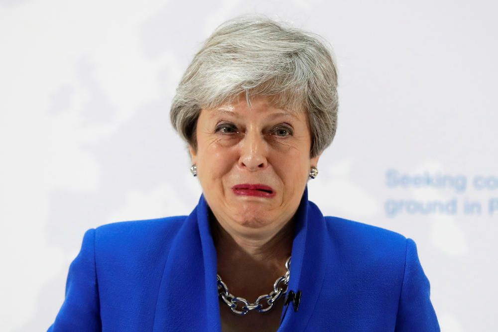 Britain's Prime Minister Theresa May grimaces ...