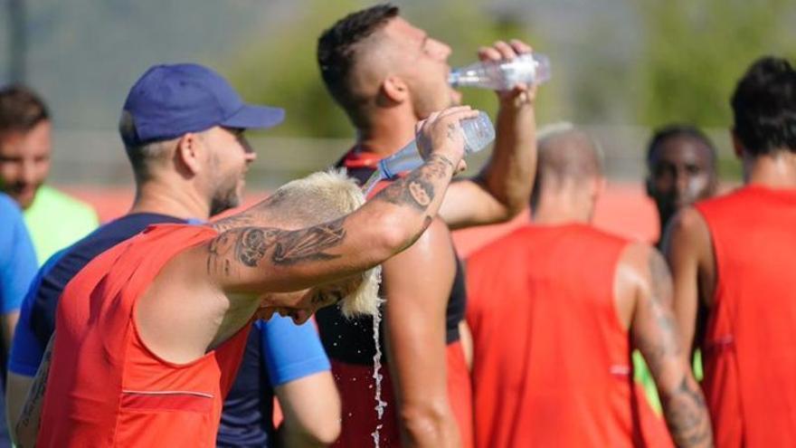 Los jugadores del Mallorca se refrescan tras un entrenamiento.