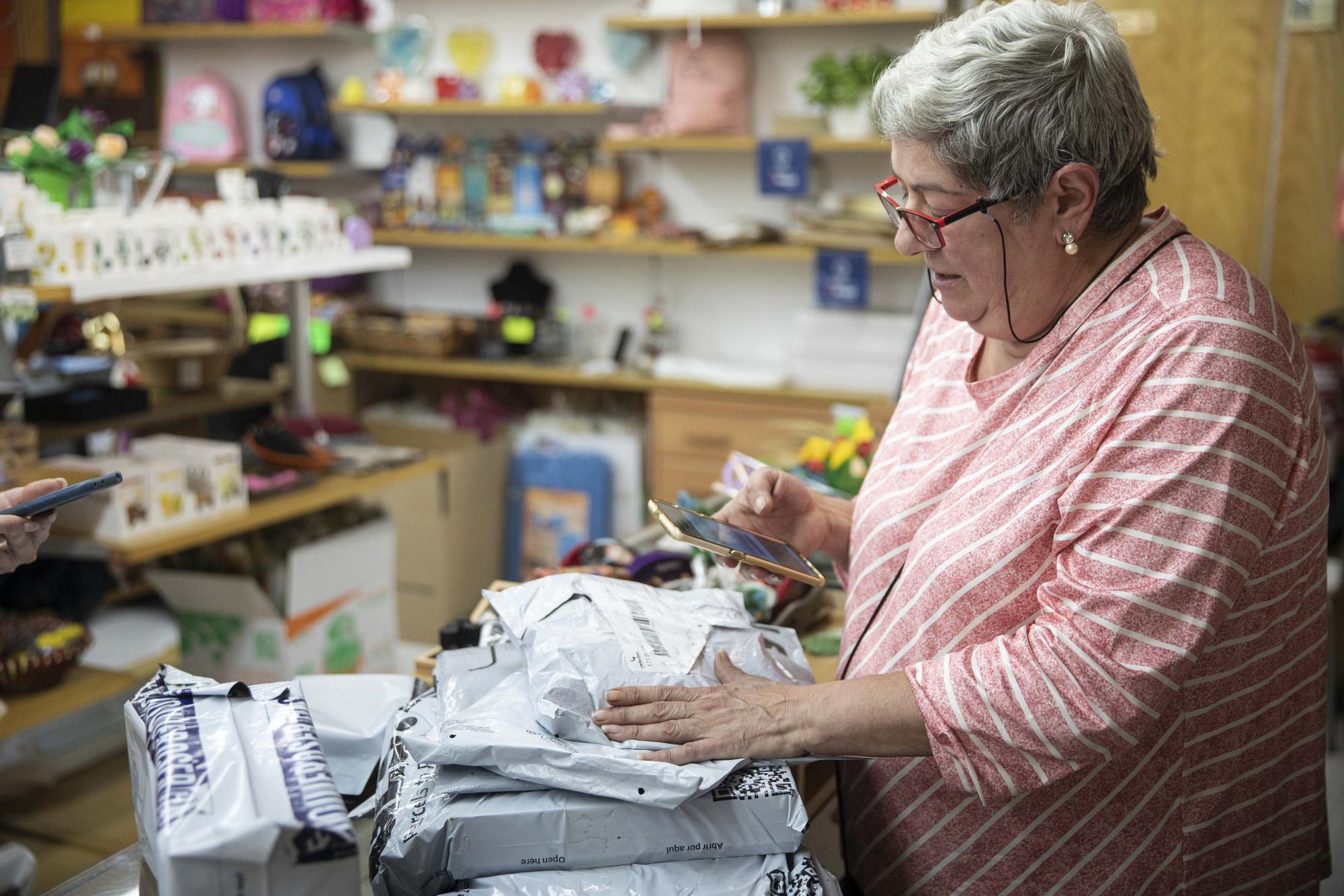 Reyes Sanagustín, la dueña de la tienda Kukaditas en Lloret de Mar, registrando la llegada de varios paquetes a su tienda para terceras personas