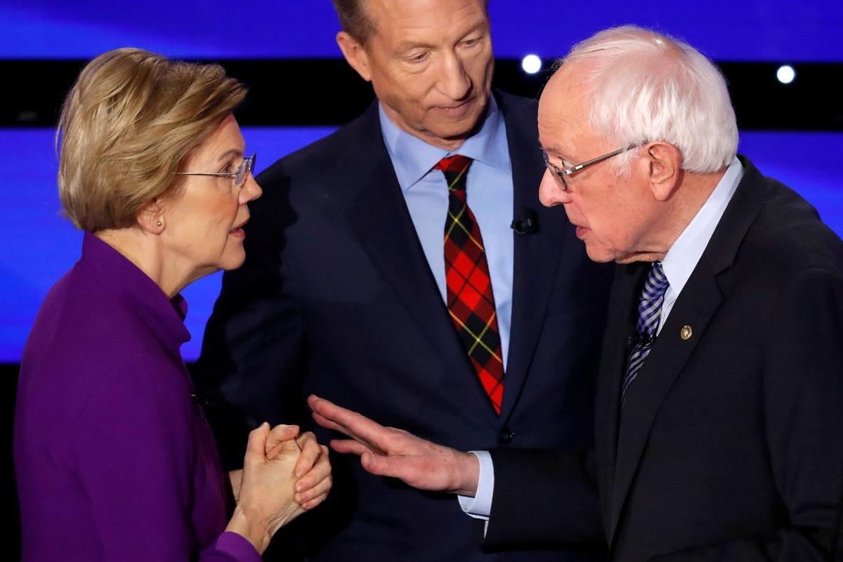 Democratic 2020 U.S. presidential candidates (L-R) Senator Elizabeth Warren (D-MA) speaks with Senator Bernie Sanders (I-VT) as billionaire activist Tom Steyer listens after the seventh Democratic 2020 presidential debate at Drake University in Des Moines, Iowa, U.S., January 14, 2020.     TPX IMAGES OF THE DAY