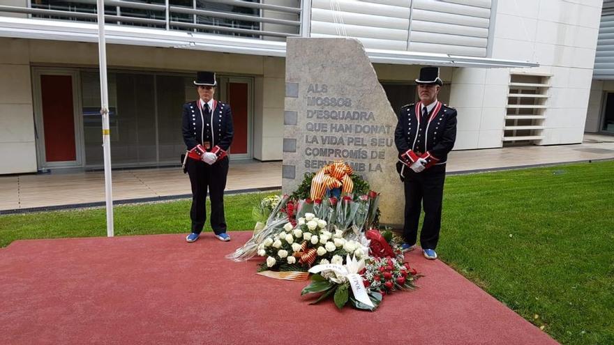 El monòlit commemoratiu custodiat per dos mossos.