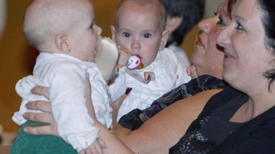 Núria y Marta, ayer, con su madre y su abuela. En el recuadro, cuando aún estaban unidas.