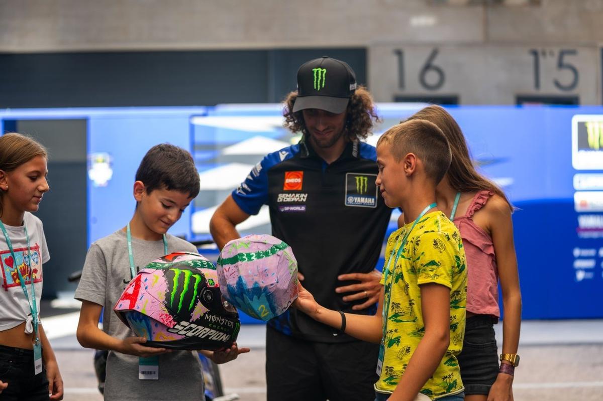 Álex Rins, junto a los cuatro niños del colegio de Castelserás que han diseñado su casco.
