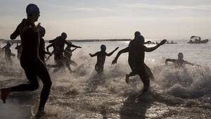 Los participantes en el Triatlón de Barcelona se lanzan al mar, con trajes de neopreno.