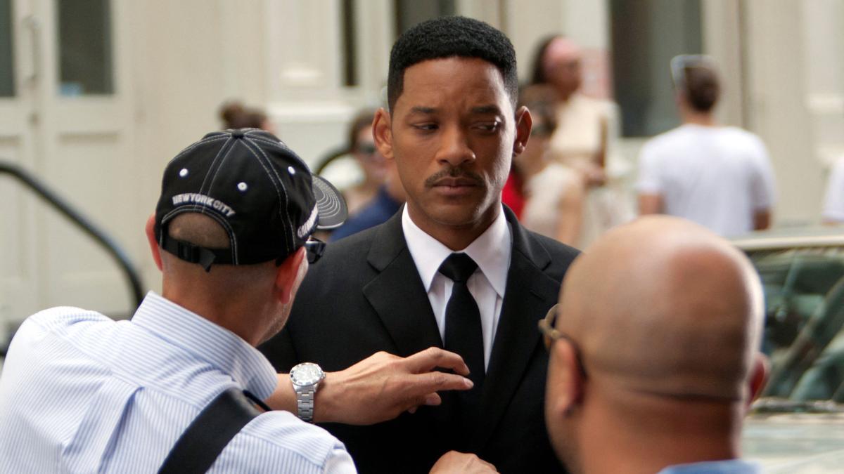 FILE PHOTO: Actor Will Smith has his tie adjusted between takes on the set of &quot;Men In Black 3&quot; in New York City