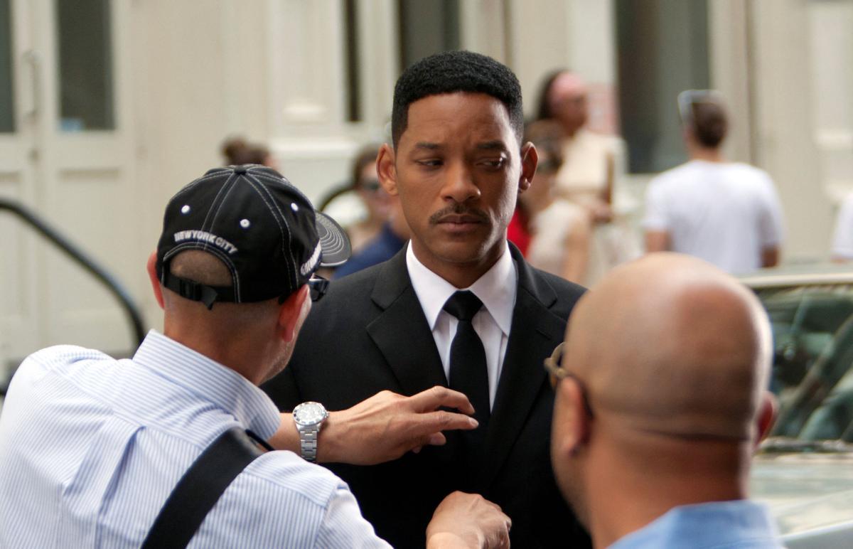 FILE PHOTO: Actor Will Smith has his tie adjusted between takes on the set of &quot;Men In Black 3&quot; in New York City