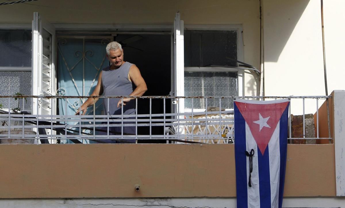 HAB31 LA HABANA (CUBA) 27/11/16.- Un hombre exhibe la bandera nacional de Cuba tras el fallecimiento del líder de la revolución Fidel Castro hoy, domingo 27 de noviembre de 2016, en La Habana (Cuba). La isla inicia esta jornada el segundo de los nueve días de luto oficial decretados por el Gobierno por la muerte del expresidente Fidel Castro, aunque los principales actos de homenaje comenzarán el lunes y se prolongarán hasta el domingo. EFE/Ernesto Mastrascusa