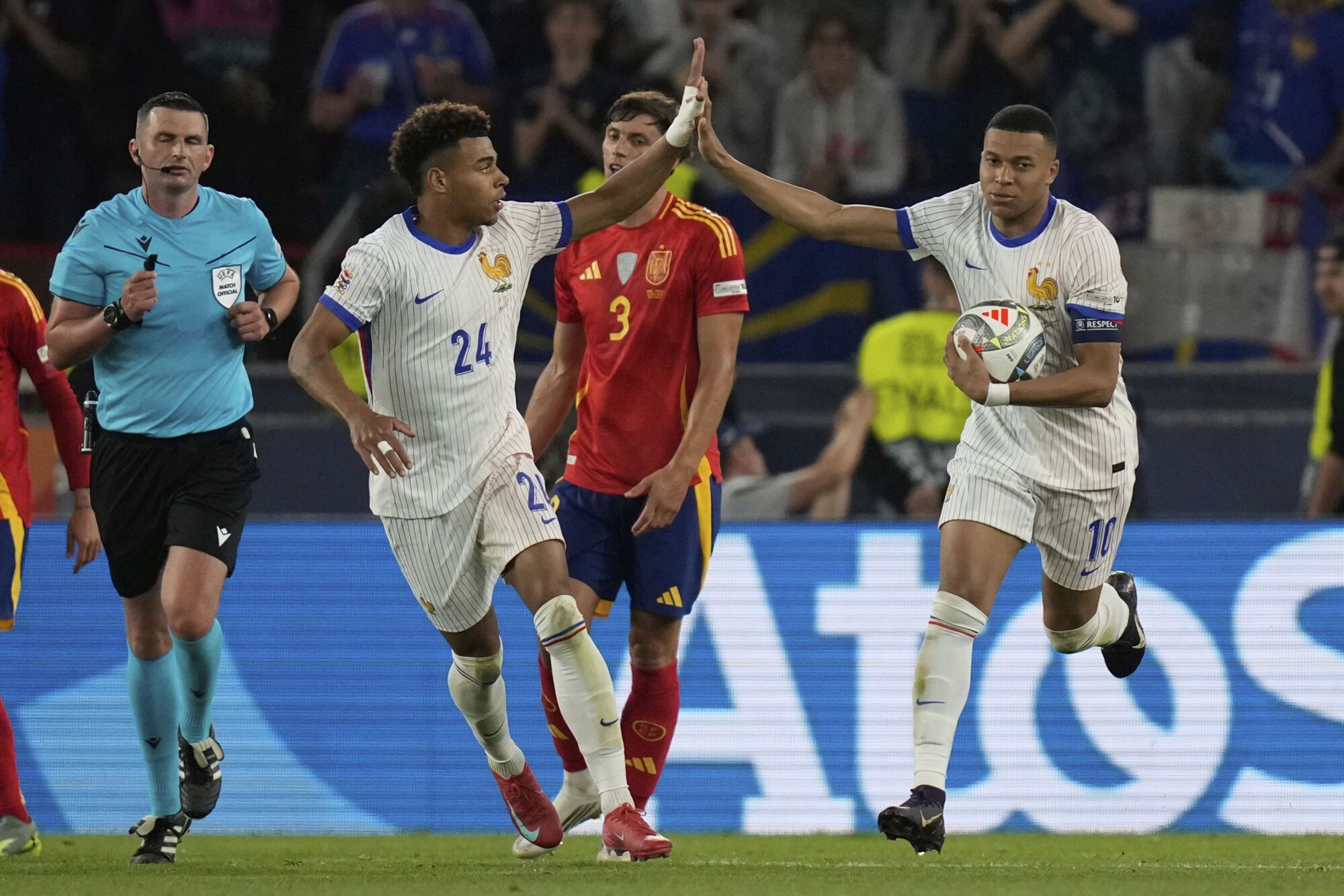 France's Desire Doue, left, and Kylian Mbappe celebrate after a goal during the Nations League semifinal soccer match between Spain and France in Stuttgart, Germany, Thursday, June 5, 2025. (AP Photo/Matthias Schrader). EDITORIAL USE ONLY/ONLY ITALY AND SPAIN