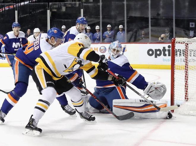 Thomas Greiss # 1 de los New York Islanders hace el primer período salvando a Alex Galchenyuk # 18 de los Pittsburgh Penguins en el Barclays Center.