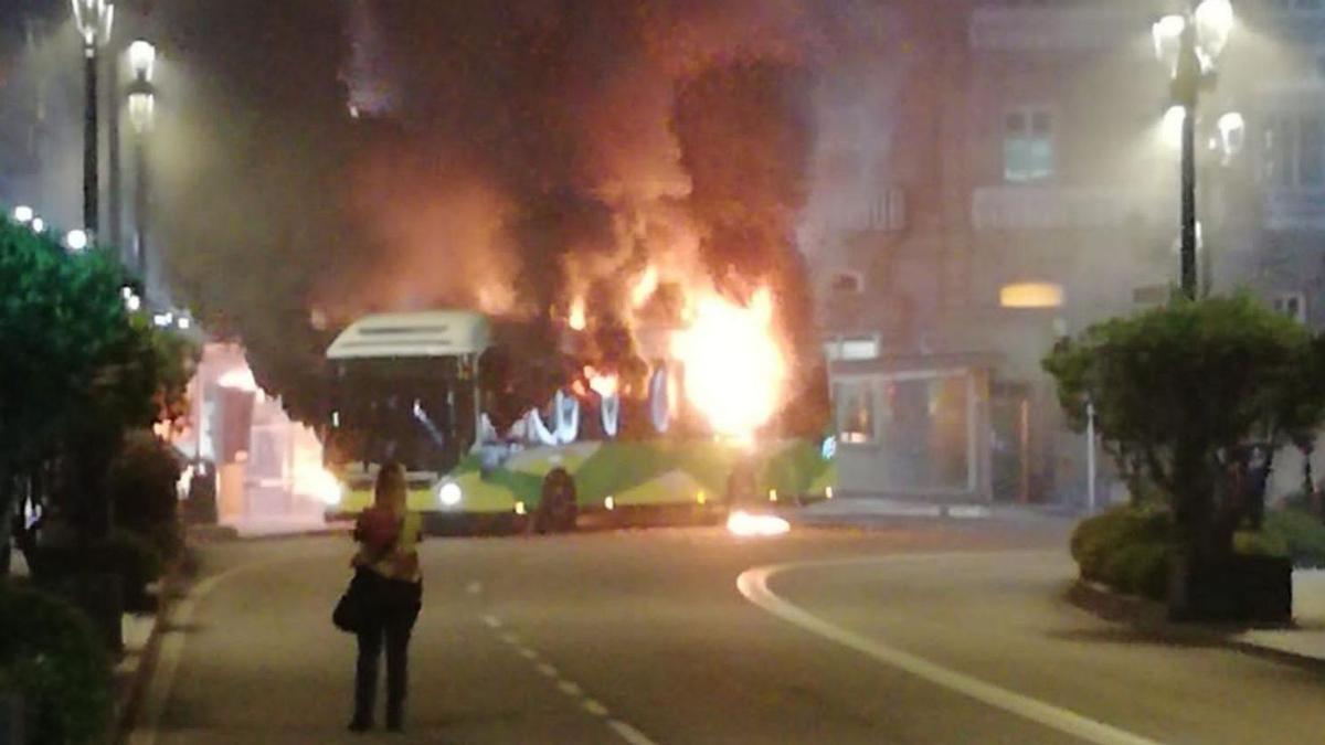 El autobús de Vitrasa en llamas, en el entorno de la farola de Urzáiz.