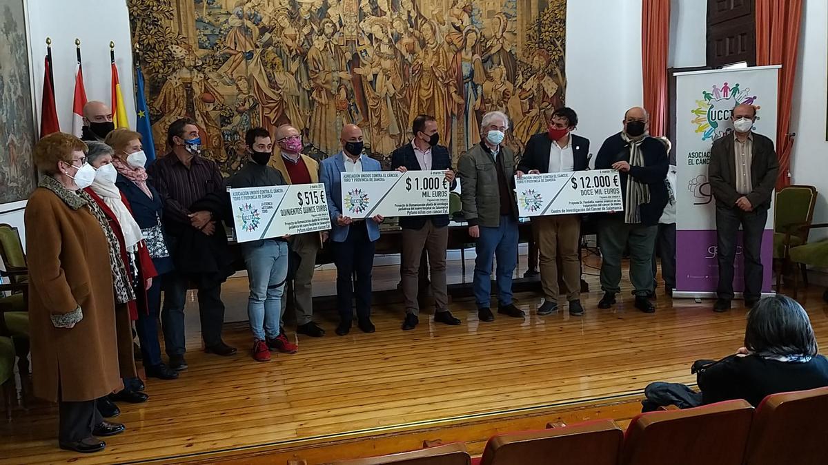 Representantes de Unidos contra el Cáncer junto a los receptores de los cheques