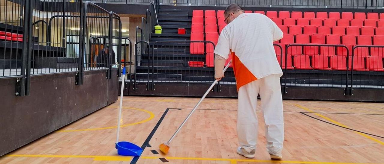 Un operario de la nueva empresa de limpieza de recintos deportivos limpia el pabellón del centro de tecnificación.  | JOSEP CARDA