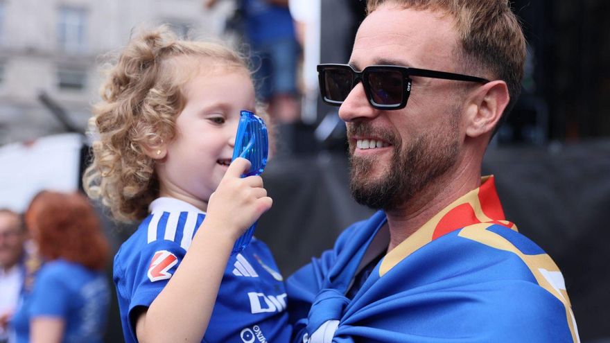Aarón Escandell, con su hija en brazos, durante la celebración del ascenso en la plaza de la Escandalera. | MARIO CANTELI