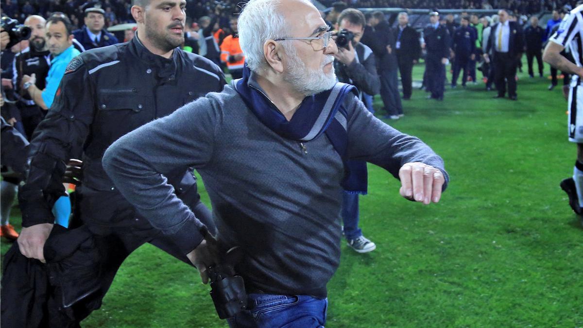 Russian-born Greek businessman and owner of PAOK Salonika, Ivan Savvides , pictured with what appears to be a gun in a holster, enters the pitch after the referee annulled a goal of PAOK during their soccer match against AEK Athens in Toumba Stadium