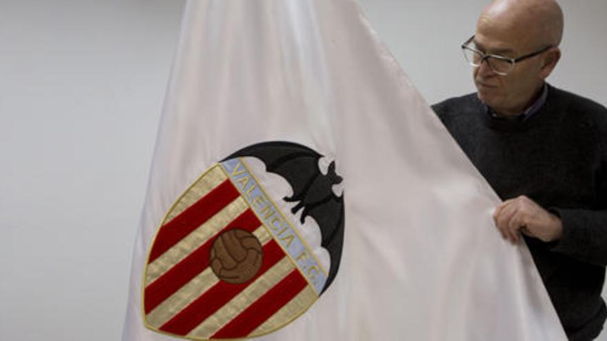 Vicente Vallés, presidente de los pequeños accionistas, con una réplica de la bandera del Valencia FC.