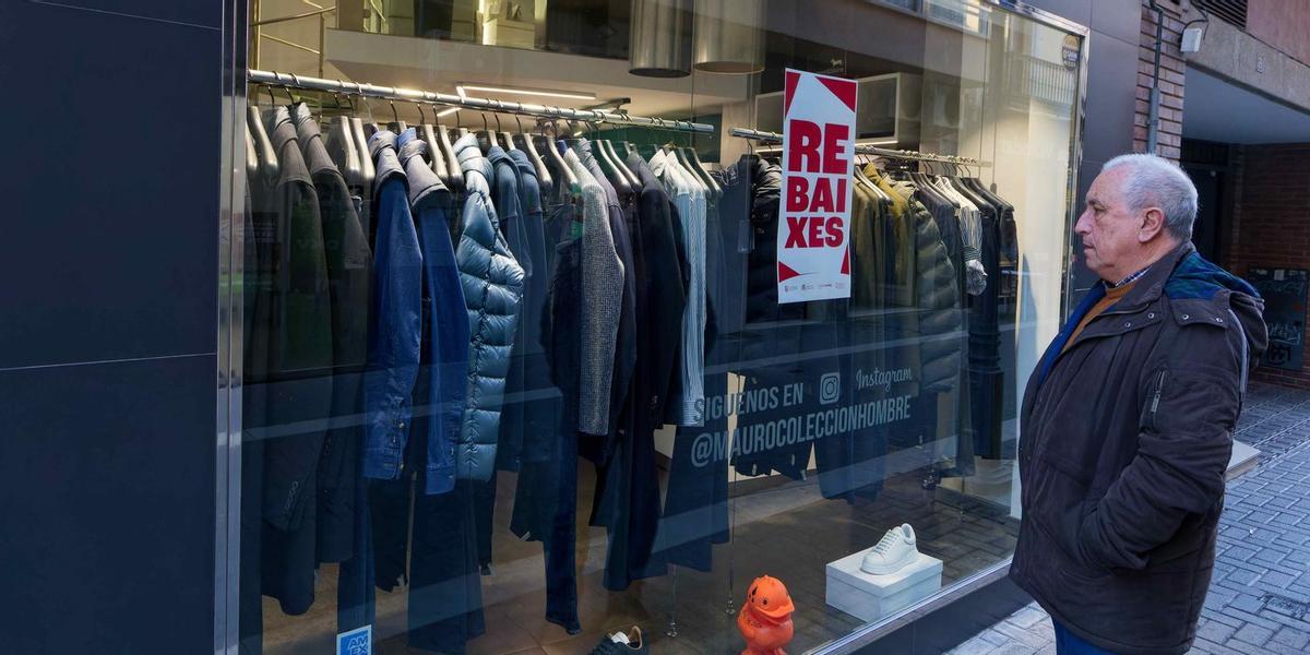 Un hombre observa el escaparate de una tienda de moda para caballeros en una de las calles peatonales del cento de Vila-real