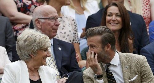 Former England soccer captain David Beckham sits with his mother Sandra on Centre Court at the Wimbledon Tennis Championships, in London