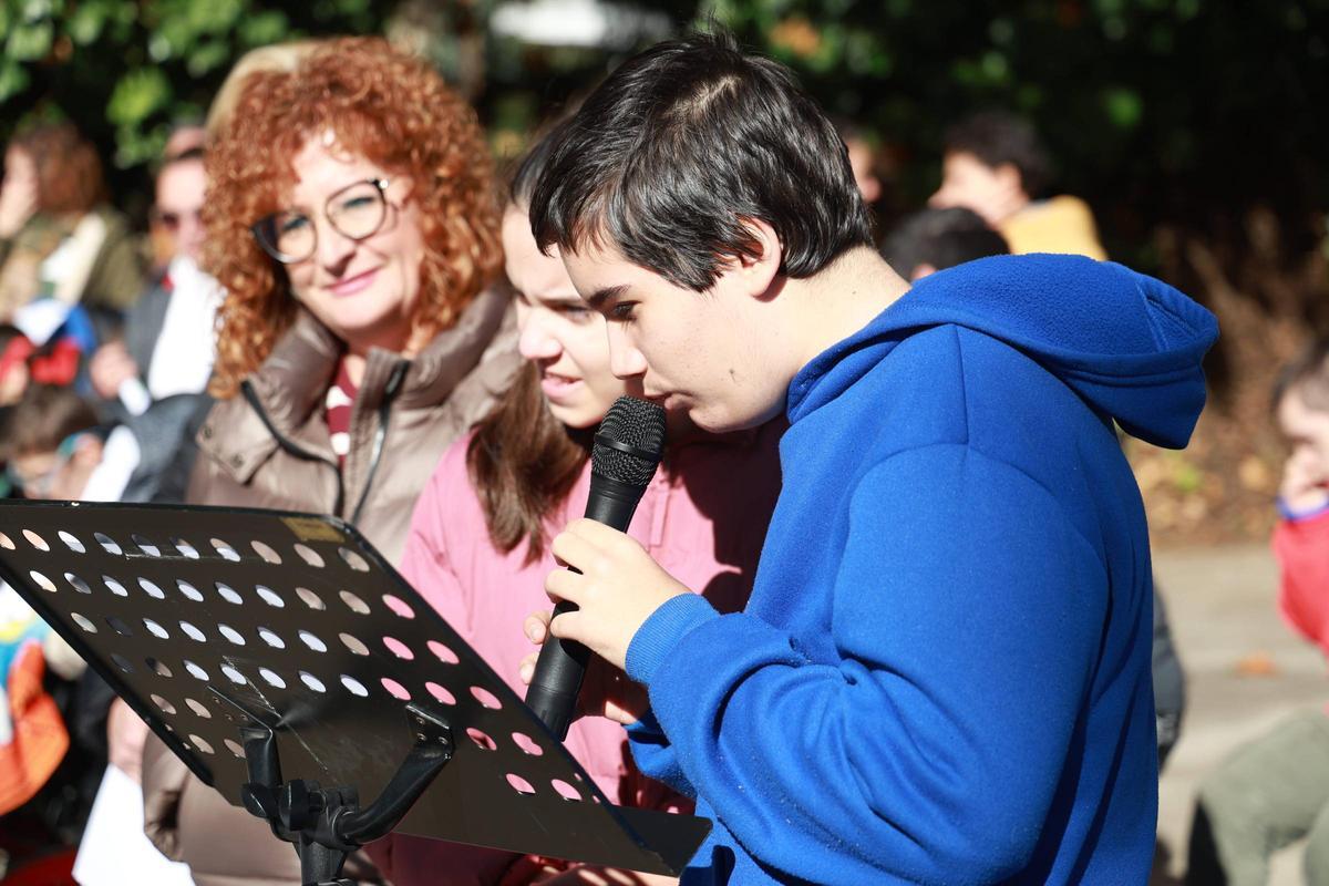 Dos alumnos leen durante el acto.