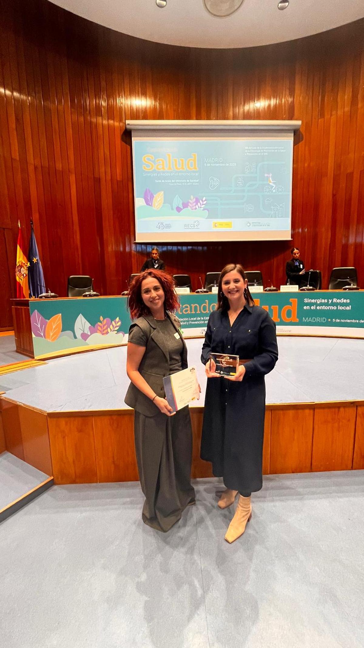 Leticia Santos y María Sanluís con el premio en el auditorio.