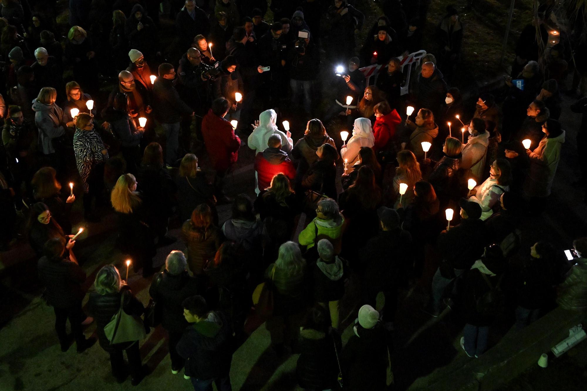 People light candles for the migrants who died in a shipwreck in Crotone