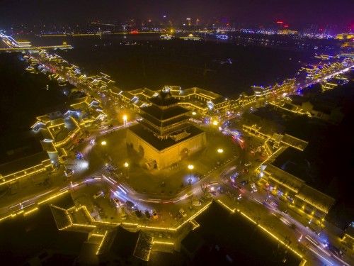 Traditional buildings of a tourist spot are seen lit up at night in Liaocheng