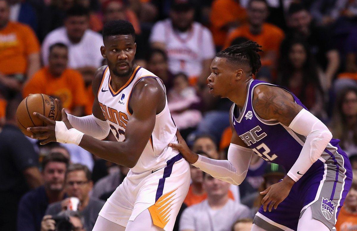 PHOENIX, ARIZONA - OCTOBER 23: Deandre Ayton #22 of the Phoenix Suns looks to pass under pressure from Richaun Holmes #22 of the Sacramento Kings during the first half of the NBA game at Talking Stick Resort Arena on October 23, 2019 in Phoenix, Arizona. NOTE TO USER: User expressly acknowledges and agrees that, by downloading and/or using this photograph, user is consenting to the terms and conditions of the Getty Images License Agreement   Christian Petersen/Getty Images/AFP