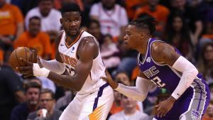 PHOENIX, ARIZONA - OCTOBER 23: Deandre Ayton #22 of the Phoenix Suns looks to pass under pressure from Richaun Holmes #22 of the Sacramento Kings during the first half of the NBA game at Talking Stick Resort Arena on October 23, 2019 in Phoenix, Arizona. NOTE TO USER: User expressly acknowledges and agrees that, by downloading and/or using this photograph, user is consenting to the terms and conditions of the Getty Images License Agreement   Christian Petersen/Getty Images/AFP