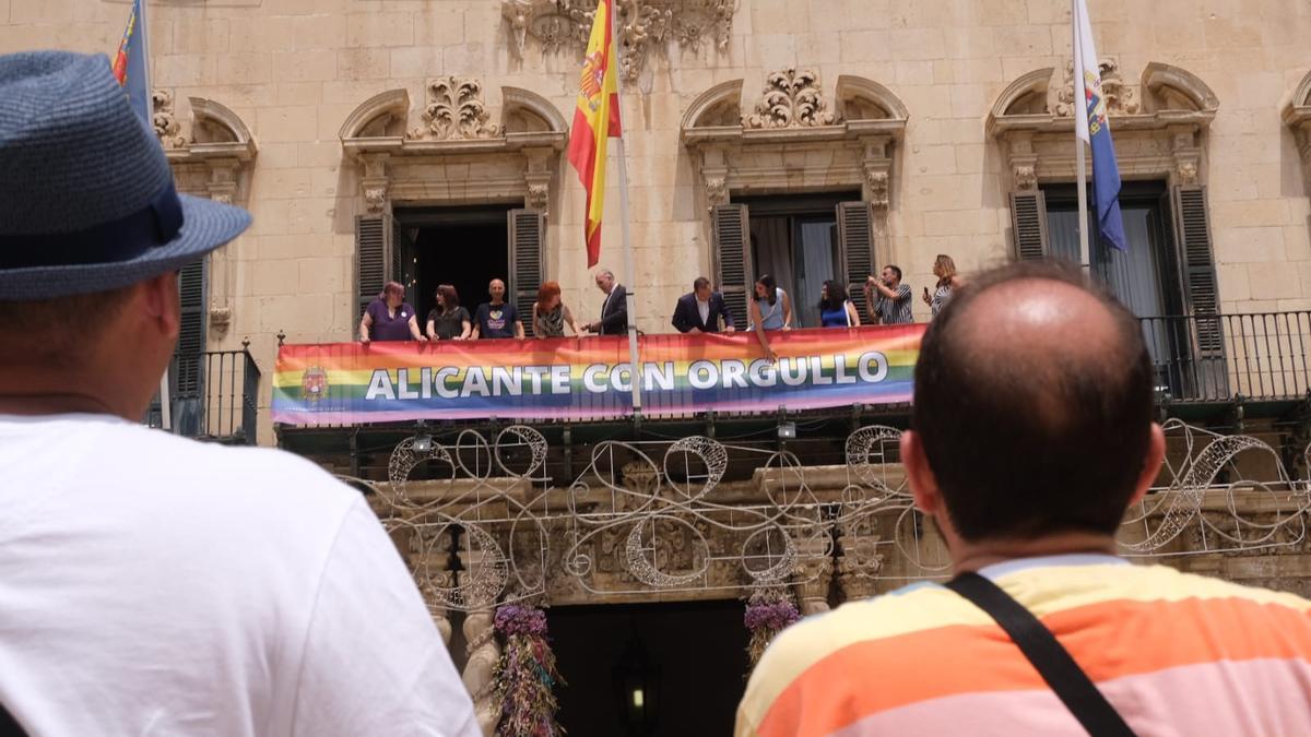 Los ediles del PP y las asociaciones Entiende y Entendemos despliegan la pancarta del Orgullo en el balcón del Ayuntamiento.