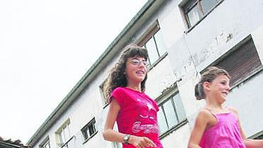 Nieves Braña, José María Ibáñez y sus hijas, junto al edificio en ruinas.