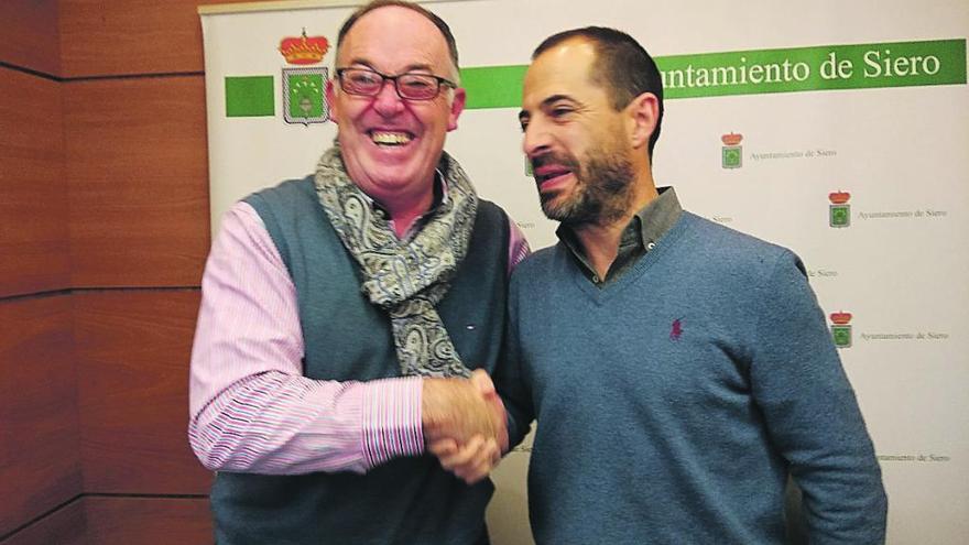 Eduardo Martínez Llosa y Ángel García, ayer, escenificando el acuerdo presupuestario con un apretón de manos en Pola de Siero.