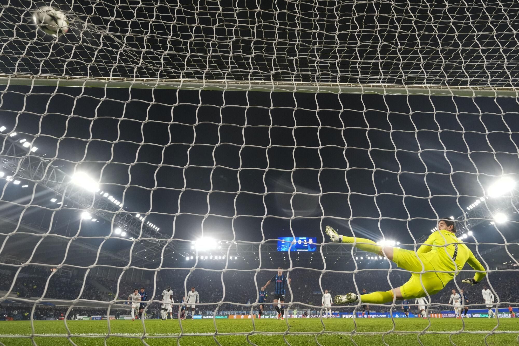 Atalanta's Charles De Ketelaere scores his side's first goal on a penalty kick past Real Madrid's goalkeeper Thibaut Courtois during the Champions League opening phase soccer match between Atalanta and Real Madrid at the Bergamo's stadium, in Bergamo, Italy, Tuesday, Dec. 10, 2024. (AP Photo/Antonio Calanni)
