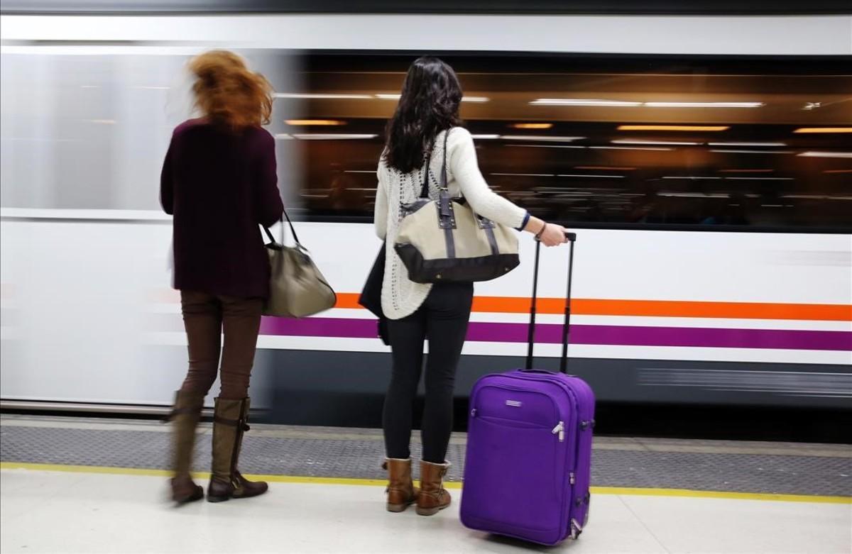 Dos pasajeras, a  punto de subir a un tren de Rodalies en la estación de Sants.