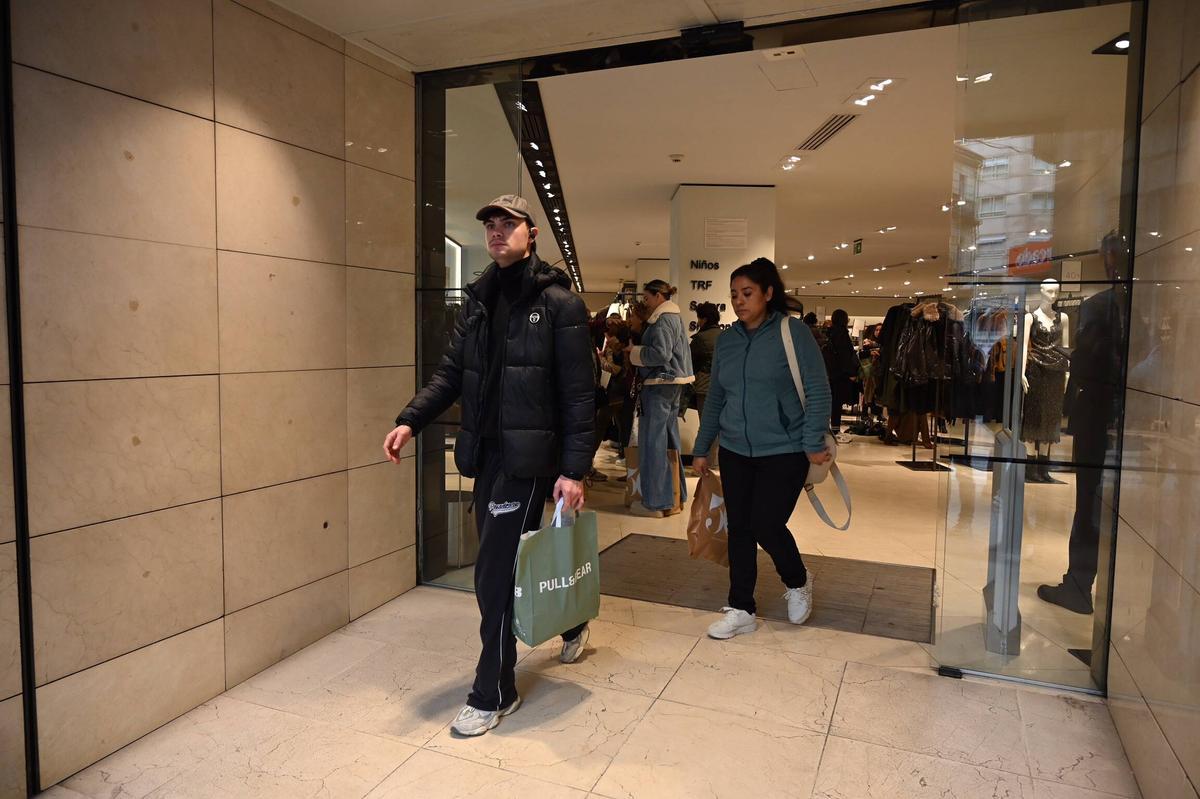 Compradores al salir de Zara.