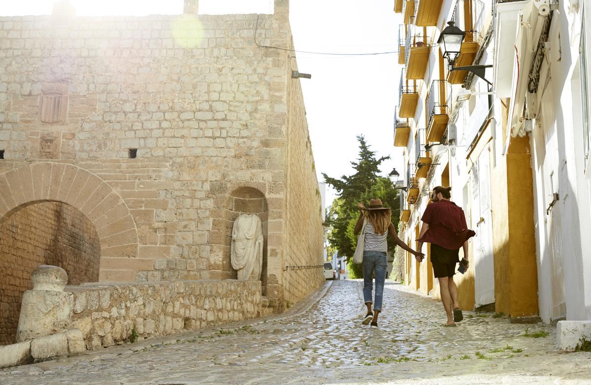 Couple walking through the streets of Dalt Vila.