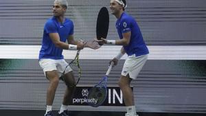 Team Europes Carlos Alcaraz, of Spain, left, and teammate Casper Ruud, of Norway, gesture toward a video screen showing a replay after call went in favor of Team Worlds Reilly Opelka, of the United States, and Alex Michelsen, of the United States, during a doubles match on the third day of the Laver Cup tennis tournament in San Francisco, Sunday, Sept. 21, 2025. (AP Photo/Jeff Chiu)
