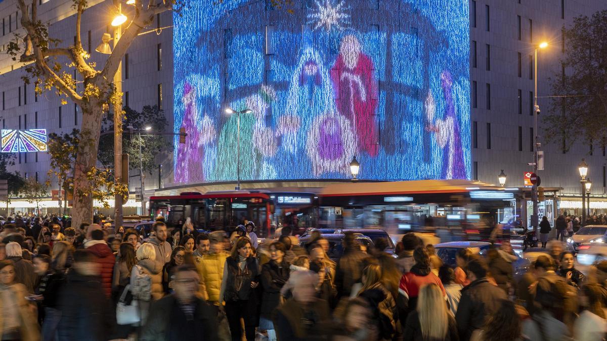 El centro de Barcelona abarrotado de gente bajo las luces de decoración de la Navidad.