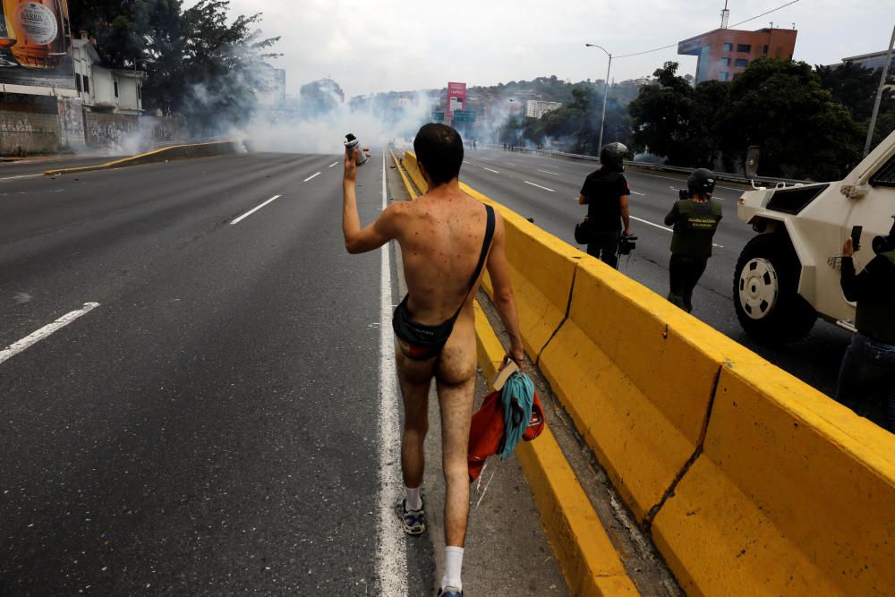 A naked demonstrator rallies against Venezuela's ...