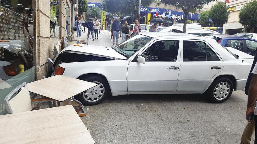 El vehículo, tras la colisión contra la terraza de la cafetería, en la calle Simón Bolívar de Vigo. // Fdv
