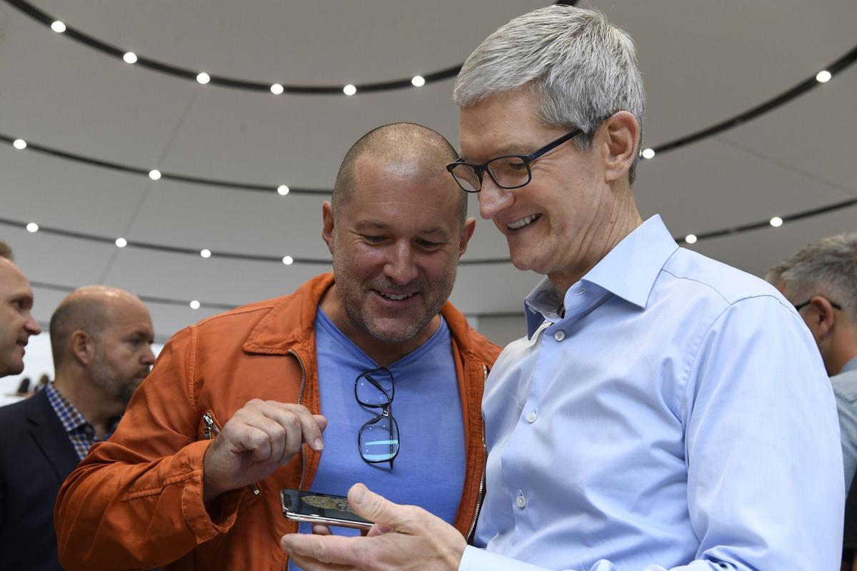 Jony Ive, chief design officer for Apple Inc., left, and Tim Cook, chief executive officer of Apple Inc., view the iPhone X during an event at the Steve Jobs Theater in Cupertino, California, U.S., on Tuesday, Sept. 12, 2017. Apple Inc. unveiled its most important new iPhone for years to take on growing competition from Samsung Electronics Co., Google and a host of Chinese smartphone makers. Photographer: David Paul Morris/Bloomberg