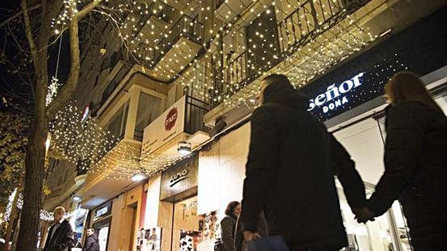 El carrer d&#039;Àngel Guimerà de Manresa amb dos dels tendals lluminosos que guarneixen enguany els comerços que han pagat la il·luminació