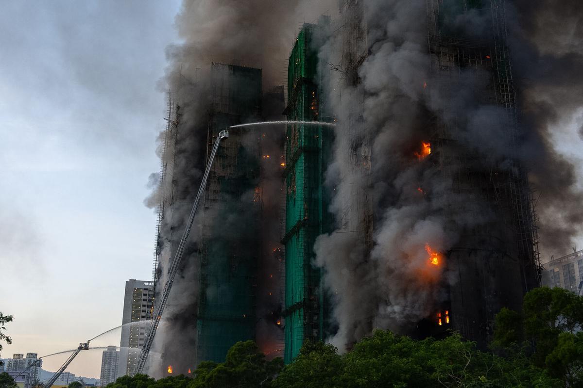 Smoke rises after a fire broke out at Wang Fuk Court, a residential estate in the Tai Po district of Hong Kongs New Territories on Wednesday, Nov. 26 2025. (AP Photo/Chan Long Hei)