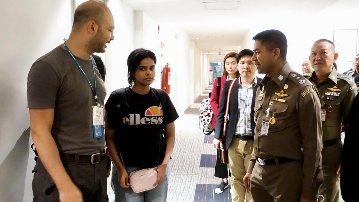 Australia dice que ACNUR le ha pedido que acoja como refugiada a la joven saudí que renunció al islam. En la foto, Rahaf, junto a oficiales de inmigración de la ONU en el aeropuerto de Bangkok.